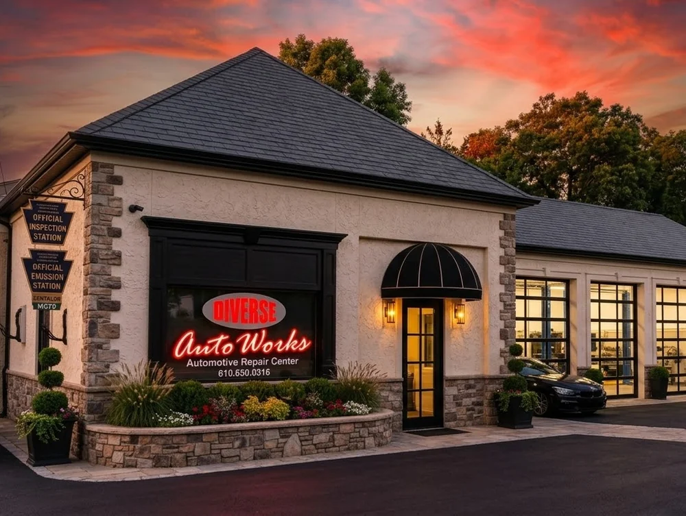 Diverse Auto Works shop front at sunset, with state inspection and emission station signs
